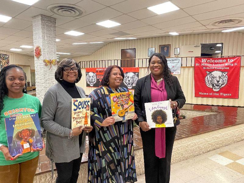 Superintendent of Schools Dr. La'Quetta S. Small, Mitea Lakins and other share thier favorite books at MLK school.