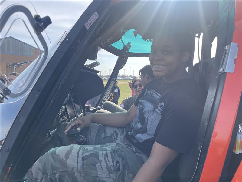 Aryiane Hill sits in Coast Guard helicopter.