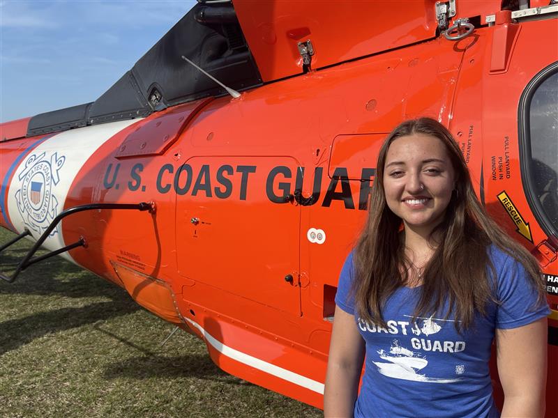 Zuzanna Turska stands by U.S. Coast Guard helicopter.